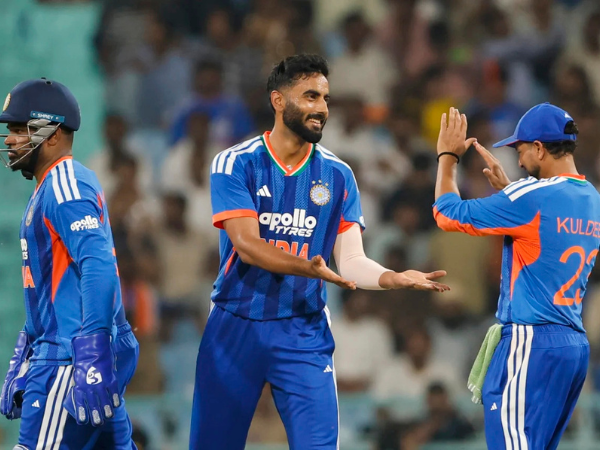 Sanju Samson, Naman Dhir, and Kuldeep Yadav celebrate after taking a wicket against the West Indies.